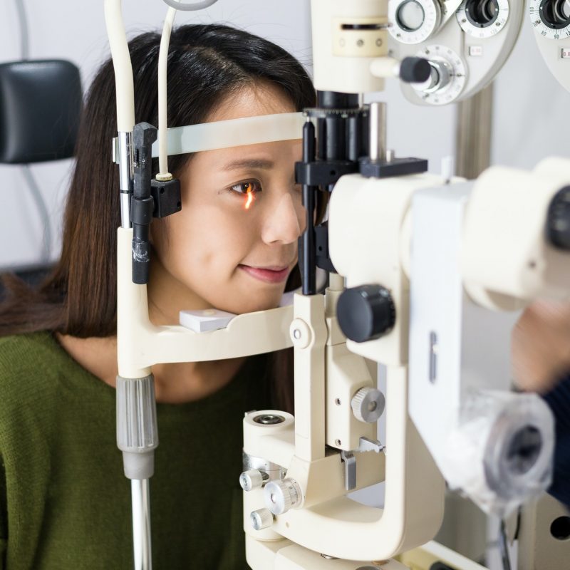 Woman having her eyes examined by Milligan Optical Eye Doctor